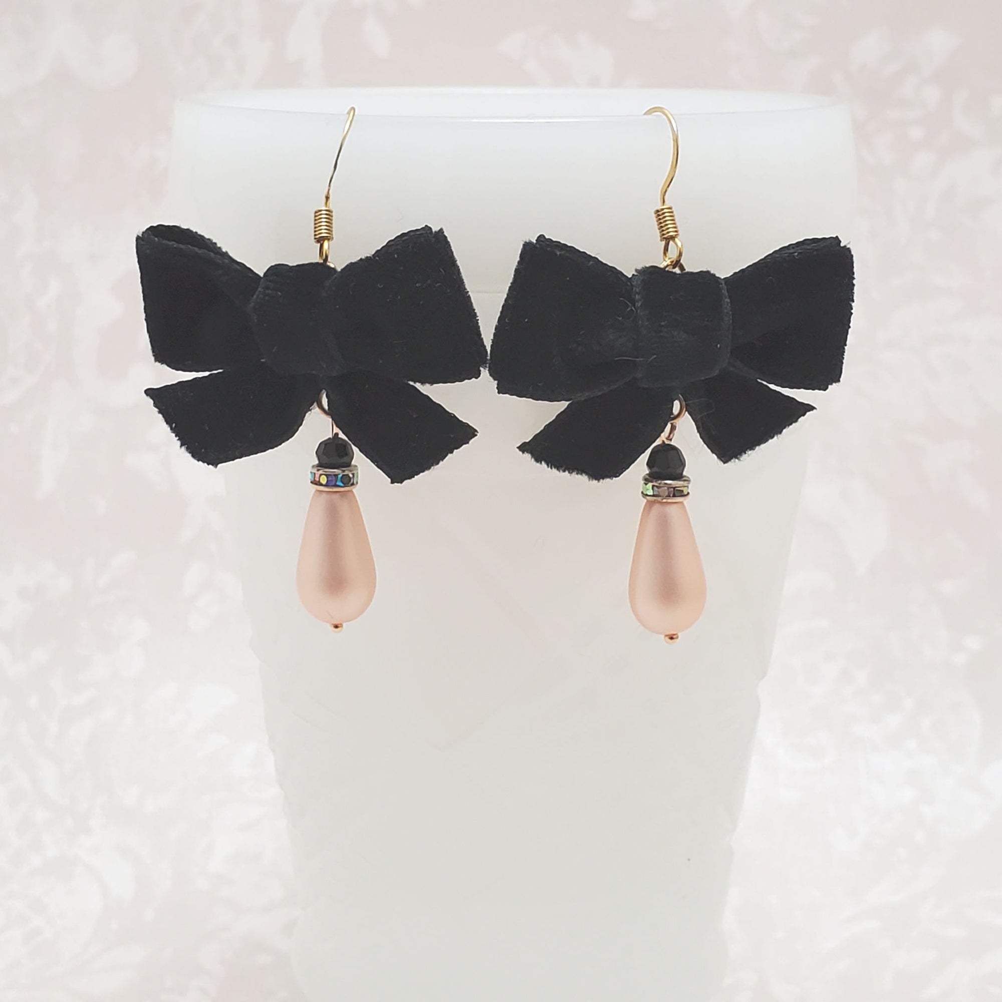 Pale rose glass pearl earrings topped with a black velvet bow
