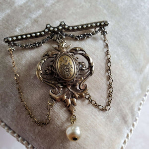 Victorian Style brooch with chains.