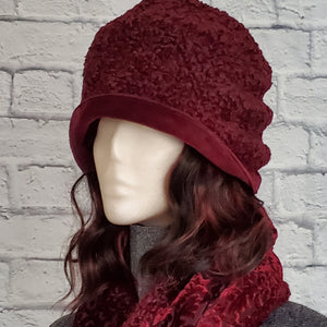 Burgundy Hat and Scarf Set with a faux Persian lamb hat that is finished with a burgundy velvet brim.  The matching scarf is reversible with one side in a Persian lam and the other in a burnout burgundy velvet. 