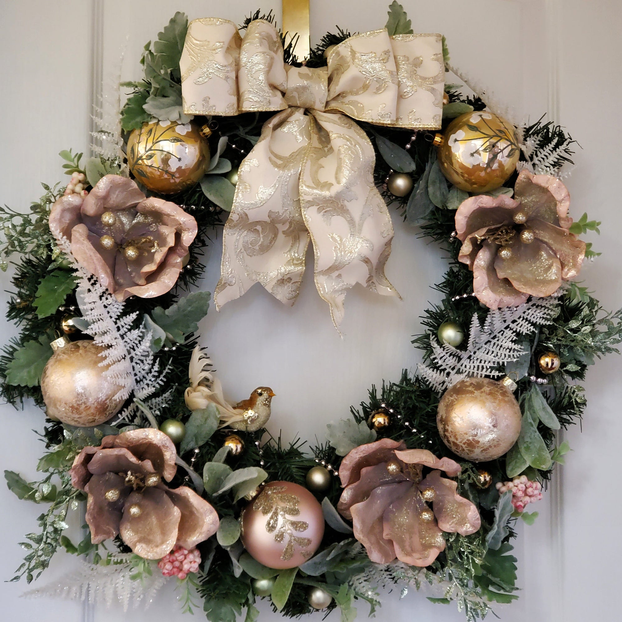 Romantic Christmas Wreath with Pink Ornaments, Pink Foil Florals and Pink Bead Garland Wrapped around an Evergreen Artificial Wreath