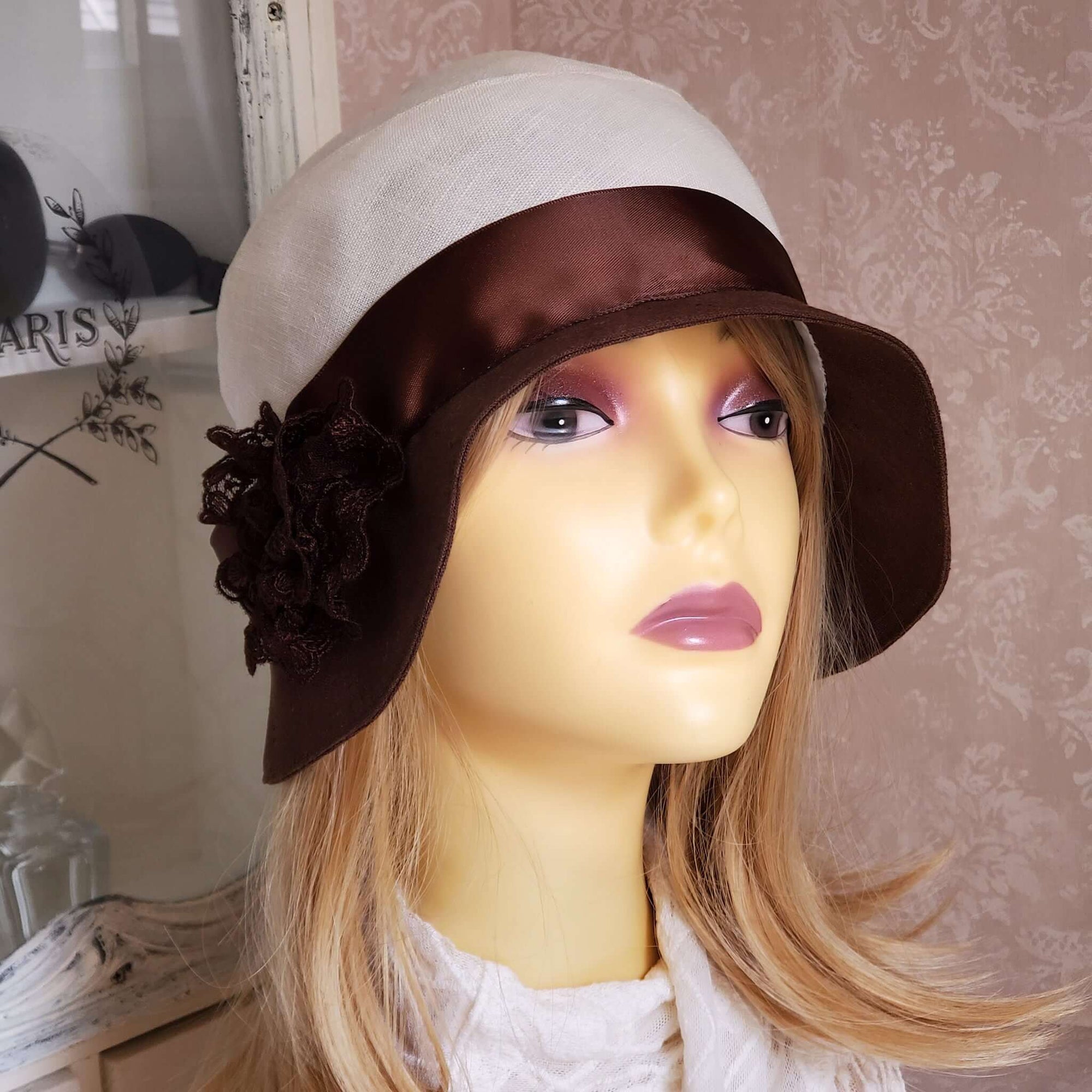 White and Brown Linen Cloche Trimmed with a Brown Satin Ribbon and a Brown Lace Rose