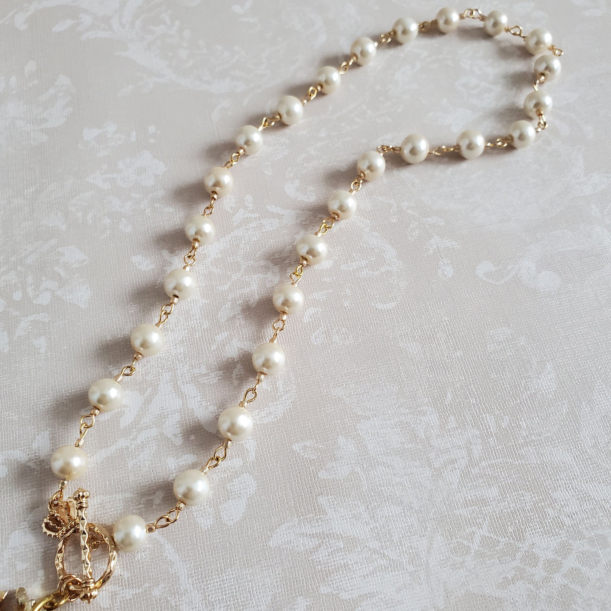 Single strand, vintage ivory faux pearl necklace with gold accent beads