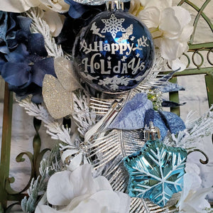 Ornaments are shatterproof and include a large navy bulb with a "Happy Holidays" message 
