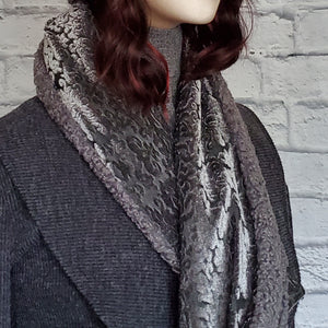 Double sided scarf with one side in a velvety damask fabric  and the other side in a faux Persian lamb fabric.
