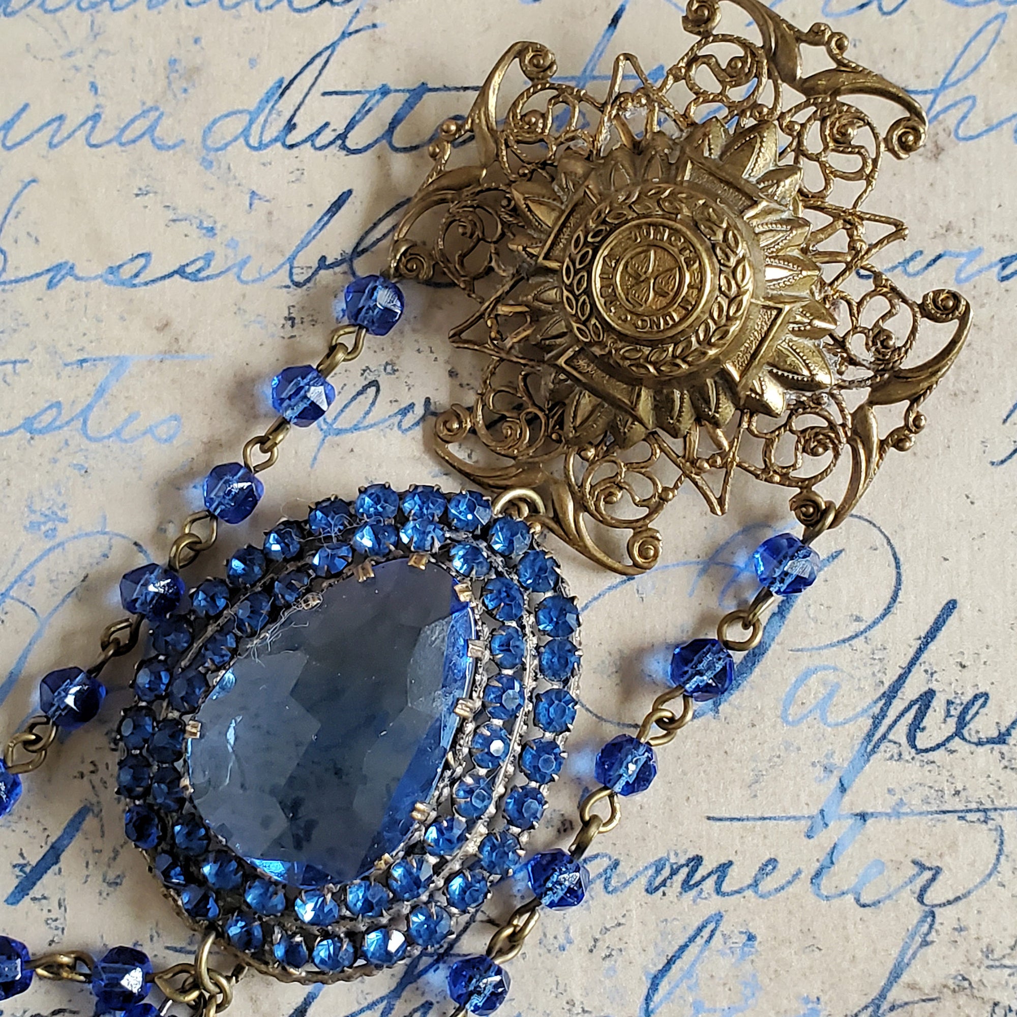 Maltese Cross Brooch with a repurposed vintage blue dress clip pendant.