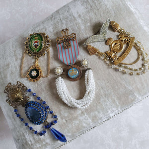 Collection of  four designer military style brooches.