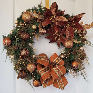 Golden berries  and gold dusted cedar sprigs  enhance the wreath.