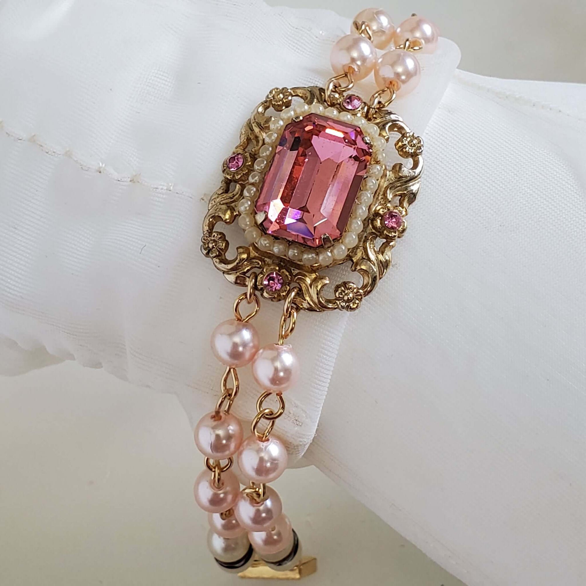 Brilliant pink vintage gemstone pendant surrounded by petite pearls.