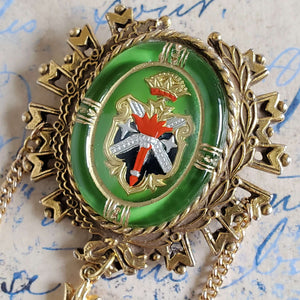 Close up of Large Pendant showing a shield, torch and crown insignia