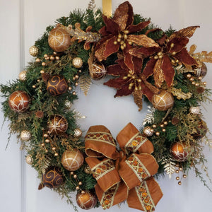 Large artificial evergreen wreath with a collection of shimmering copper, chocolate brown, gold and antique bronze ornaments.
